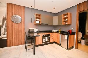 a kitchen with a counter and a clock on the wall at Atelier Aedes - Studio 15 in Maarif +3 photos