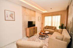 a living room with a couch and a tv at Atelier Aedes - Studio 15 in Maarif