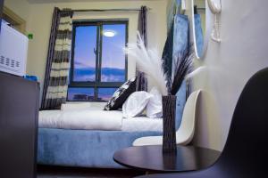a room with a couch and a table and a window at Brenda luxury homes in Nairobi