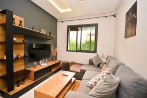 a living room with a couch and a table at Atelier Aedes - Studio 2 in Maarif