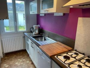 a kitchen with a sink and a counter top at Les Coquillages in Trégastel +4 photos