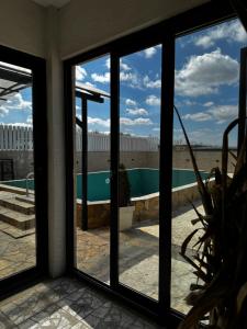 a view of a pool through a window at Apartments Vila Brzi & Beka in Šabac