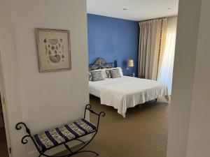 a bedroom with a bed and a chair in it at Apartamento Puerto Sotogrande Marina in Sotogrande