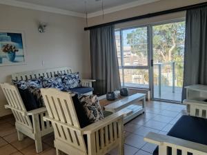 a living room with two chairs and a couch at SANTANA 107 Margate in Margate