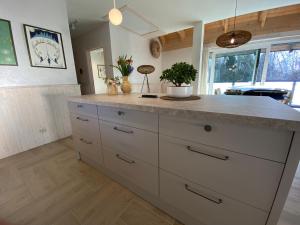 a kitchen with a large island with a counter top at Choriatiki in Dębki +36 photos