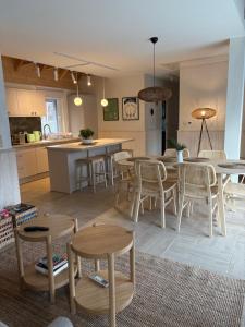 a kitchen and dining room with tables and chairs at Choriatiki in Dębki