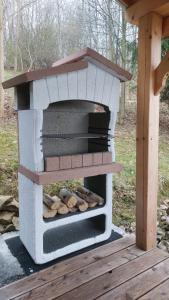a outdoor wood fired oven with logs in it at Świerkowy Zakątek u Bacy in Wieprz