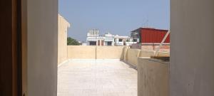a view of a balcony from an open doorway at NKS Service Apartment in Pondicherry