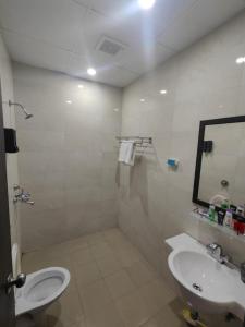 a bathroom with a sink and a toilet and a mirror at The Label Stay Skyscraper in Gurgaon +13 photos