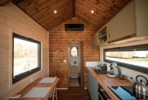 an interior view of a kitchen in a tiny house at La Tiny Cluny in Cluny
