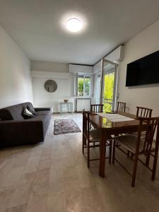 a living room with a table and a couch at REGINA GARDESANA Lakeshore in Garda