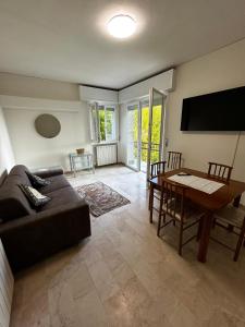 a living room with a couch and a table at REGINA GARDESANA Lakeshore in Garda