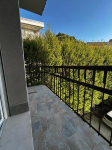 a balcony with a black fence and trees at REGINA GARDESANA Lakeshore in Garda