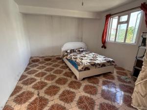 a bedroom with a bed and a tiled floor at NS apartments in Curepipe Road Station