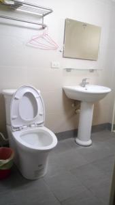 a bathroom with a toilet and a sink and a mirror at 隔壁棟 in Hsinchu City