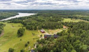 an aerial view of a house on a hill next to a river at Häradssätter gård 2 in Valdemarsvik