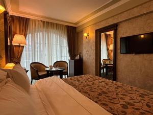 a hotel room with a bed and a television at Germir Palas Hotel - Special Class in Istanbul