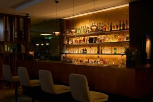 a bar with a bunch of bottles on the shelves at Sternen Hotel Wolfurt in Bregenz