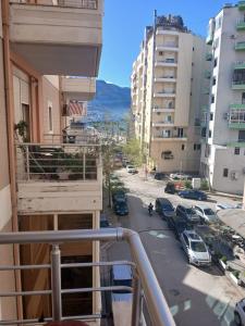 a balcony with a view of a street and buildings at Roxy's house in Vlorë