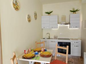a kitchen with a table with plates on it at Casa Nonna Leondina in Spoltore