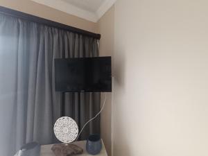 a room with a flat screen tv on a wall at SANTANA 107 Margate in Margate