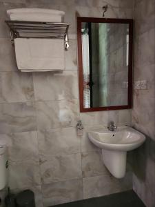 a bathroom with a sink and a mirror at Mimi Home in Arusha +12 photos