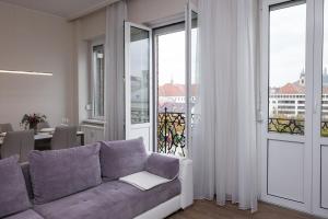 a living room with a couch and a balcony at Top City Center Apartment! in Budapest