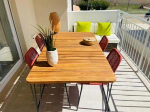 a wooden table and chairs on a balcony at Vasto Marina Dreamhouse in Vasto