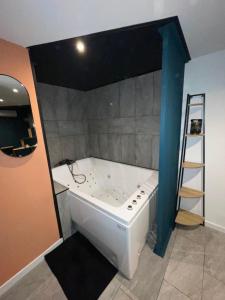 a large bath tub in a room with a ladder at Trinidad Suite Jacuzzi in Aubagne