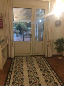 a door with a rug in front of it at Hotel La Palma in San Teodoro