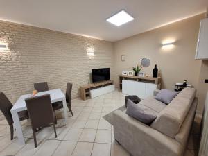 a living room with a couch and a table at Appartamenti Castel Ritaldi Il Sagrantino in Bruna