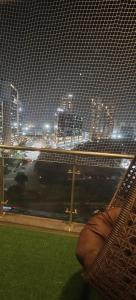 a window with a view of a city at night at The Label Stay Skyscraper in Gurgaon