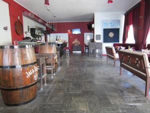 a bar with wooden barrels in the middle of a room at Sandalis Hotel in Pythagoreio