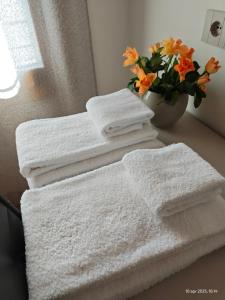 a pile of white towels sitting on a bathroom counter at Dalla Afra Agrialloggi in Valdobbiadene +38 photos
