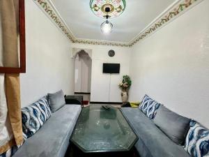 a living room with a couch and a tv at Mhamid airport in Marrakesh