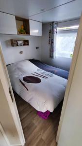 a bedroom with a large bed in a room at Mobilhome in Saint-Arnoult