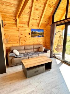 a living room with a couch and a coffee table at Eternum Glamping in Žabljak