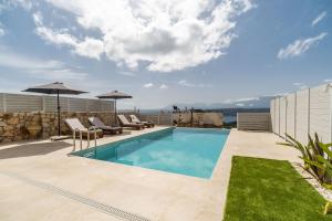 a swimming pool on the roof of a house at Fantasea Villas, villa Lumi in Stérnai
