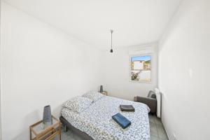 a white bedroom with a bed and a window at Au bout de la rue la Mer- T3 Jardin Piscine PARKING WIFI BY HC in Carqueiranne +18 photos