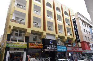 a yellow building on the side of a street at Zagy Hotel in Dubai