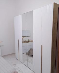 a white cabinet with glass doors in a room at Appartamento Matteo in Trappeto +8 photos