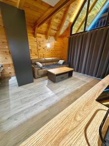 a living room with a couch and a table at Eternum Glamping in Žabljak