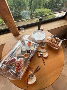 a table with a tray of breakfast foods on it at Les Terrasses de la Borie in Mandagout