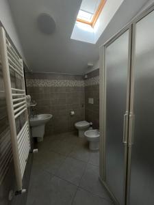 a bathroom with a toilet and a sink at Hotel Gandolfo in Alassio