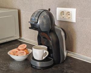 a coffee maker on a counter with a cup of coffee at Bepo Studio Apartment - FREE PARKING in Split +5 photos