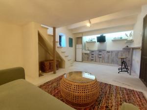 a large living room with a large rug and a table at La Casita de La Abubilla in L'Aldea