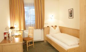Łóżko lub łóżka w pokoju w obiekcie Hotel Garni Forelle