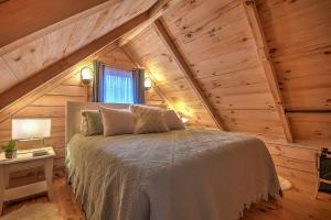 a bedroom with a bed in a wooden attic at Luxury in the Smokey Mountains Pet Friendly with Hot Tub in Elizabethton