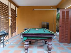 a pool table in the middle of a room at jomtien summer villa,4BR in Jomtien Beach