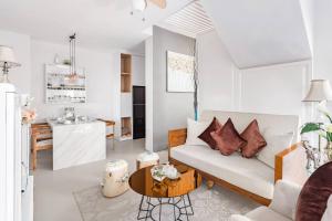 a living room with a couch and a table at Saka Luxury Villa in Jimbaran